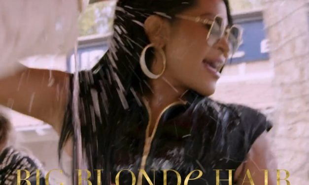 Jen Shah’s Gold Square Sunglasses and Black Zip Up Romper