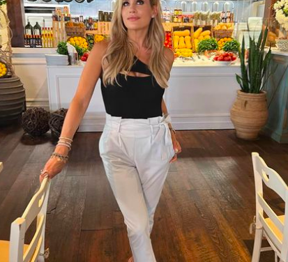 Jackie Goldschneider’s Black One Shoulder Bodysuit